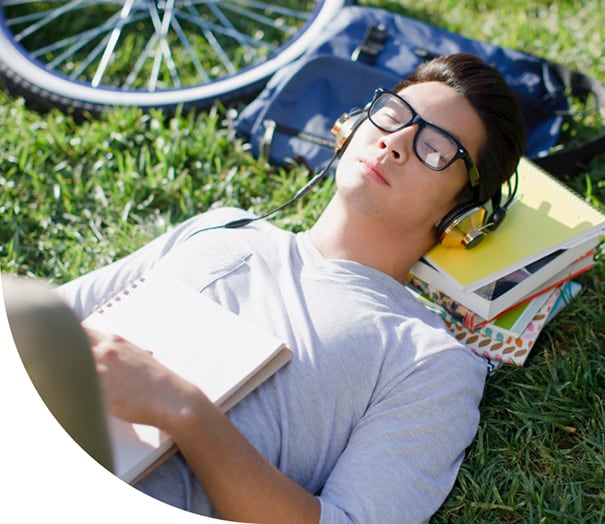 Bar exam student with headphones relaxing outside