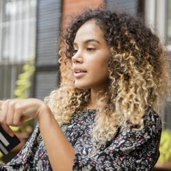 Woman using a tablet and holding a credit card.