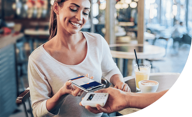 Woman using Apple Pay to buy breakfast.
