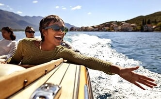 Woman smiles while on a boat ride.