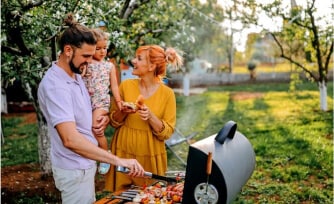 A young family enjoys a holiday barbeque after pre-planning their banking transactions.