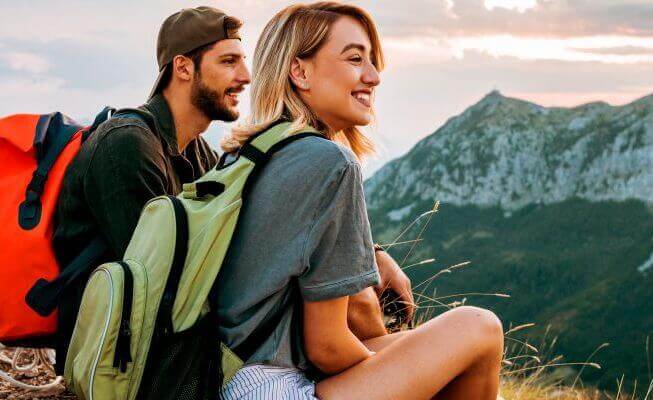 Man and woman discuss savings account interest rates during their hike.