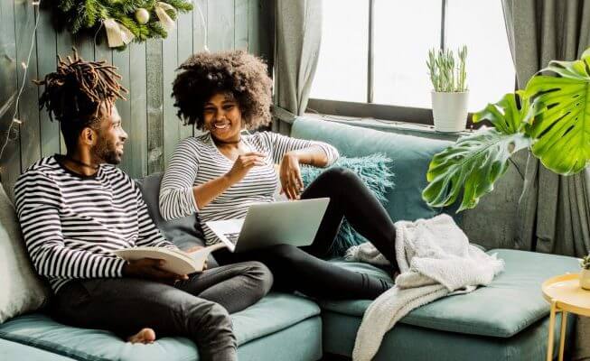 Couple relaxing at home discuss different IRA accounts.