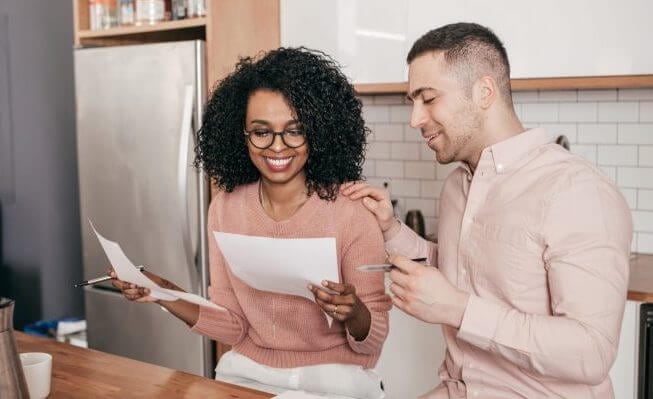 couple reviewing paycheck statements