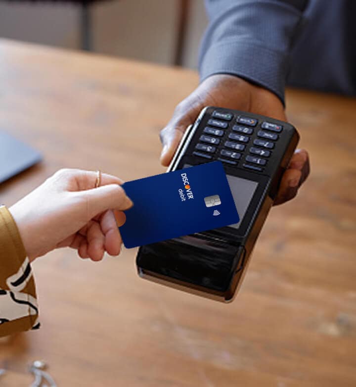 Customer using Discover Cashback Debit card to make purchase.