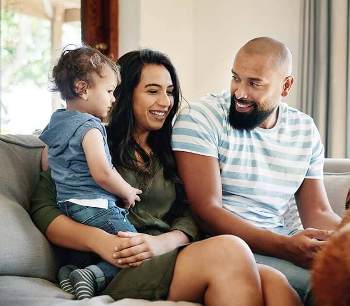 Family smiles as they discuss their retirement plan.