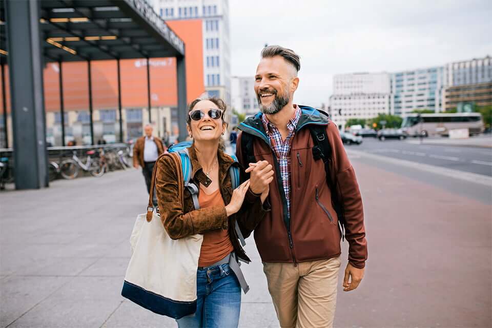 Couple walks down the street discussing money market interest rates.