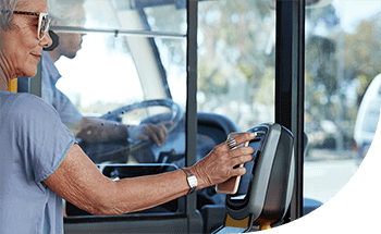 Older woman provides Samsung Pay while taking public transportation.