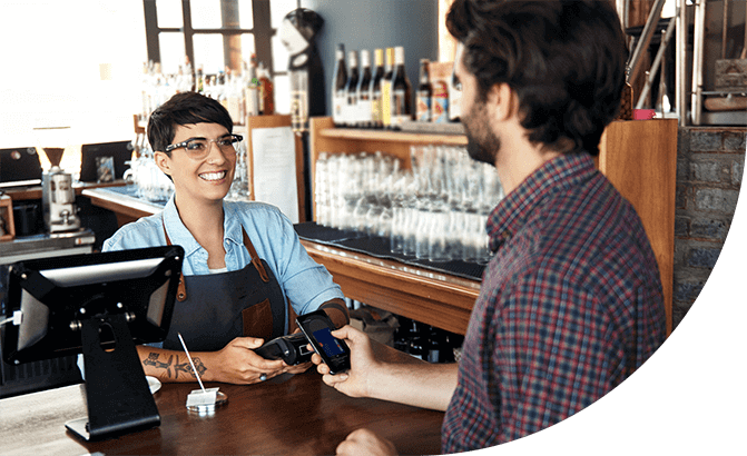 Waitress accepting Samsung Pay from customer at restaurant.