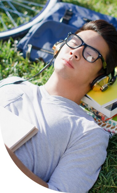 Bar exam student with headphones relaxing outside