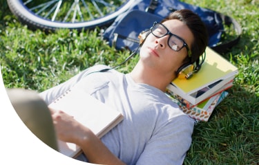 Bar exam student with headphones relaxing outside