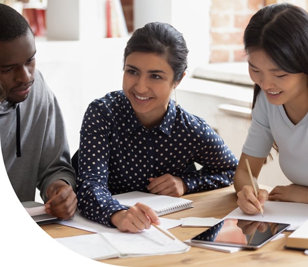 3 graduate students at a desk