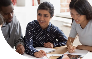 3 graduate students at a desk