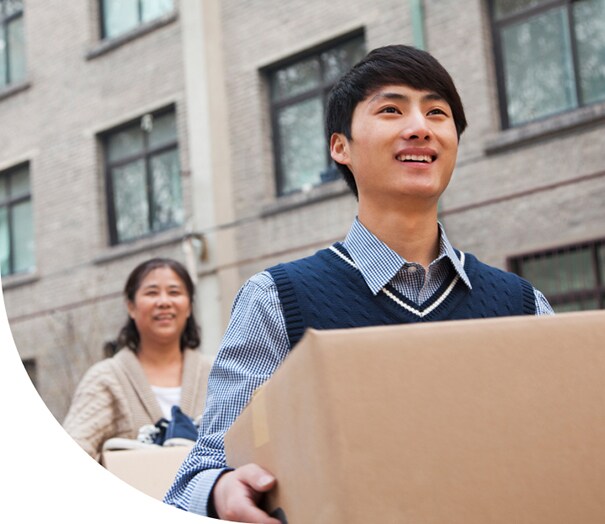 Parent helping student with moving boxes