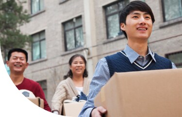 Parent helping student with moving boxes