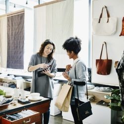 A store worker uses a card reader to swipe a customer’s credit card.
