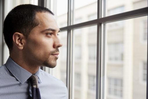 Young professional looks out window.