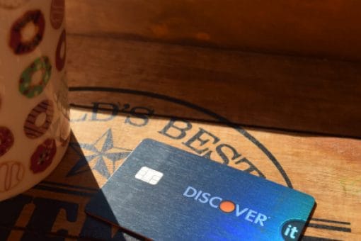 Discover it credit card lays on a table in the sun