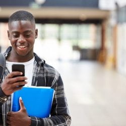 A college student learns about credit card requirements on his mobile phone.