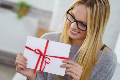 Woman holding an envelope tied with a ribbon