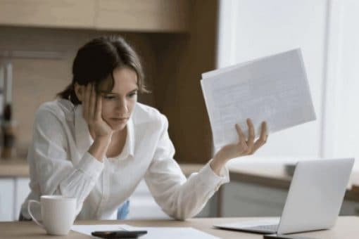 A frustrated woman looks over her credit card statements.