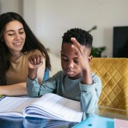 A college student tutors a younger student as a side hustle.