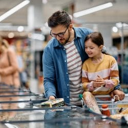 Father and daughter shop at the supermarket.