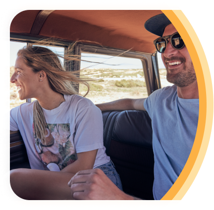 A smiling older couple on a boat on a sunny day.