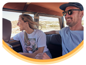 A smiling older couple on a boat on a sunny day.