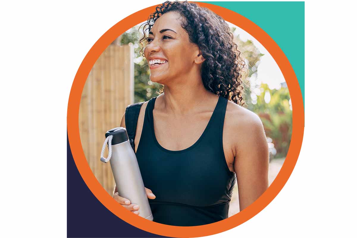 Smiling man holding a mini doughnut