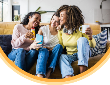 Three women friends smiling and chatting with each other