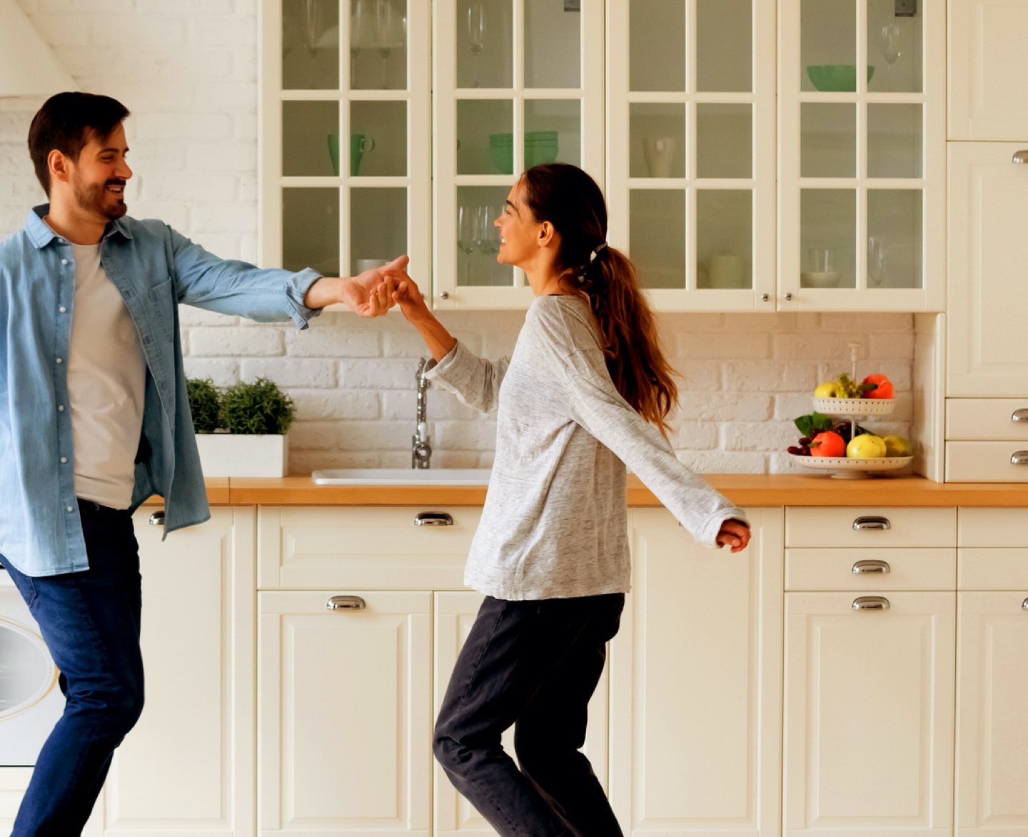 Image of a man and woman dancing together in their new kitchen