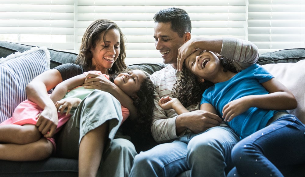 Family on couch laughing