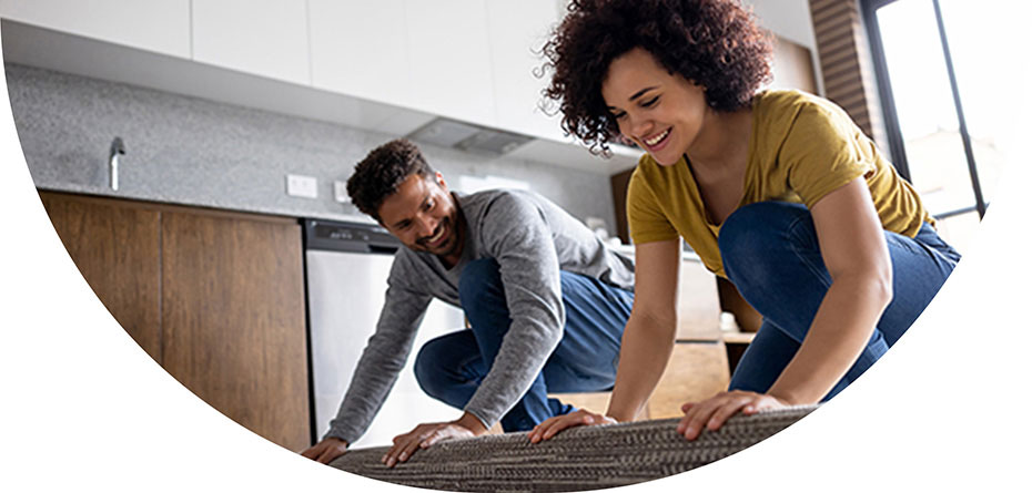 Image of a couple rolling out a rug