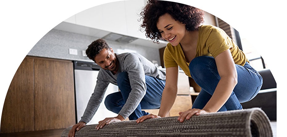 Image of a couple rolling out a rug