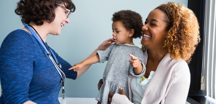 Image of doctor interacting with a woman and her child