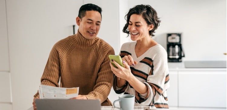 Image of a couple checking their finances on the phone