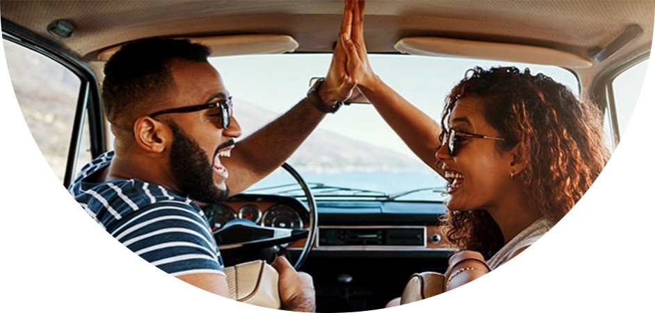 Image of man and woman high-fiving each other in the car