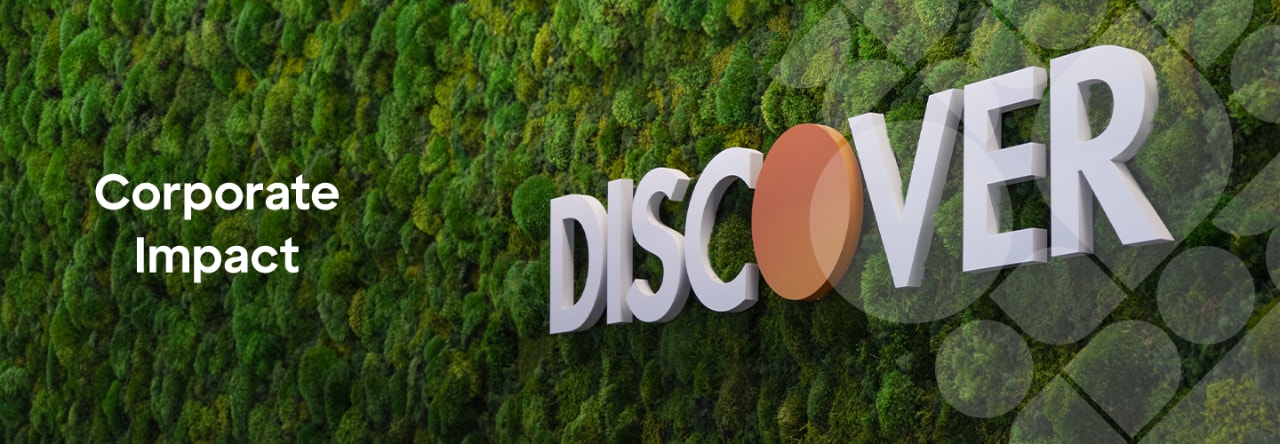 Discover brand name sign mounted on a living wall of green moss, next to the title of this page: "Corporate Impact".