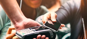 Woman paying at restaurant with Mobile Device