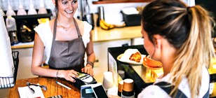 Woman paying at coffee shop with Digital Wallet