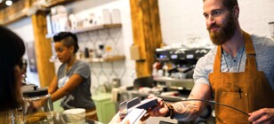 Woman paying at coffee shop with Digital Wallet