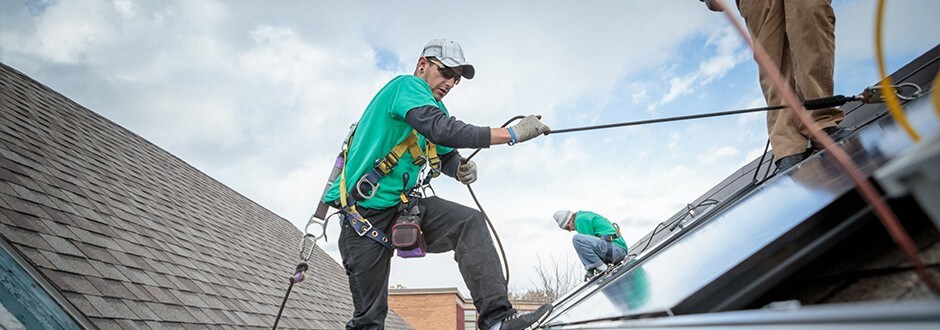 Contractors adding solar panels during a remodel from a refinance