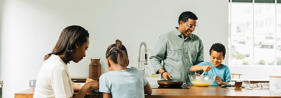 Family cooking in their kitchen appreciating the benefits of homeownership 