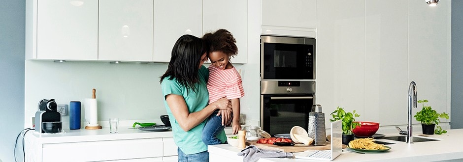 Mother and daughter in their beautiful kitchen after completing the home improvement project by using home equity