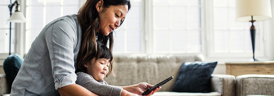 Woman comparing home equity loan rates on her phone