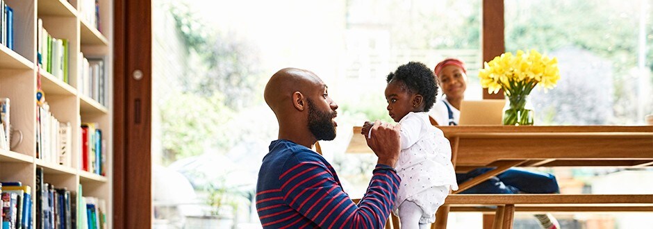 Father taking a break from comparing the best home equity loan rates by spending time with family