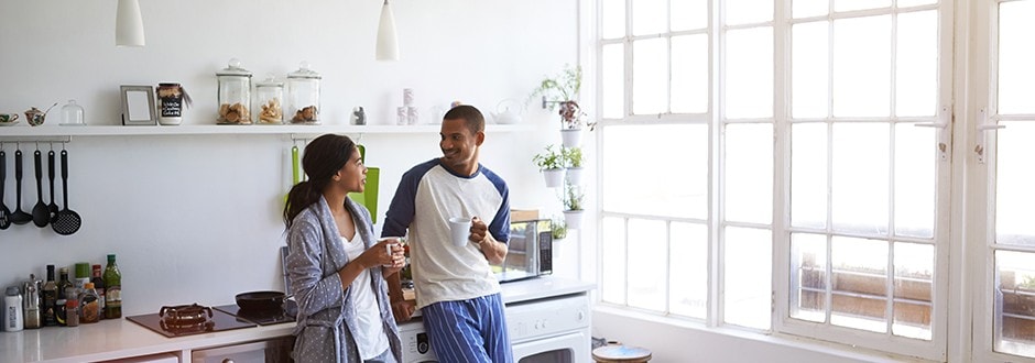 Family in kitchen discussing their different options to consolidate their medical bills