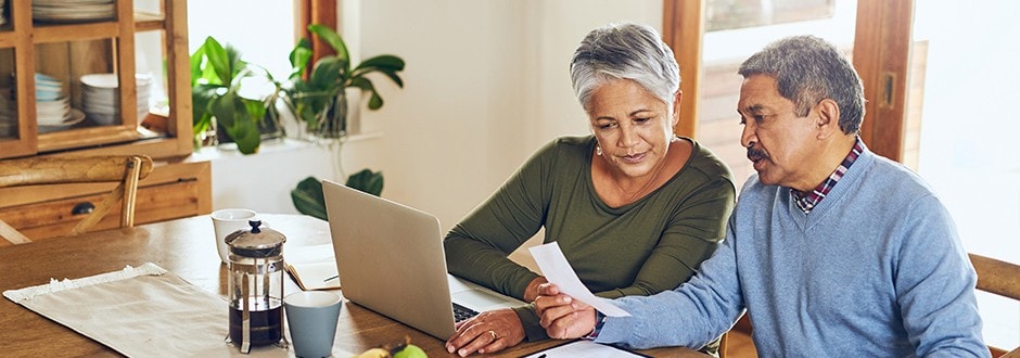 Couple at a laptop comparing lenders and reviewing current home equity loan rates.