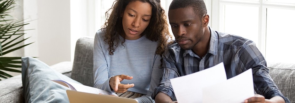 • Couple calculating how much equity they have in their home so that they can apply for a home equity loan for home improvement